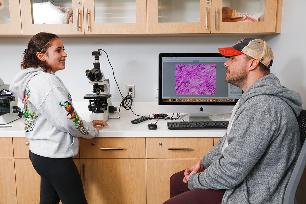 tutors looking at a microscopic image on a monitor